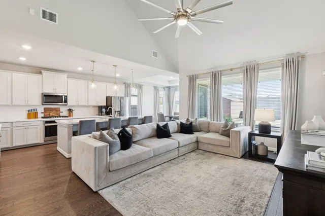 a living room with furniture and a large window