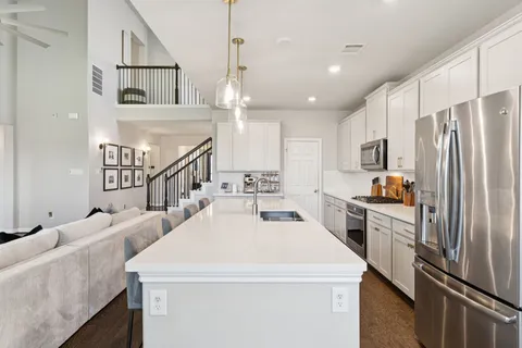 a kitchen with counter top space stainless steel appliances and cabinets