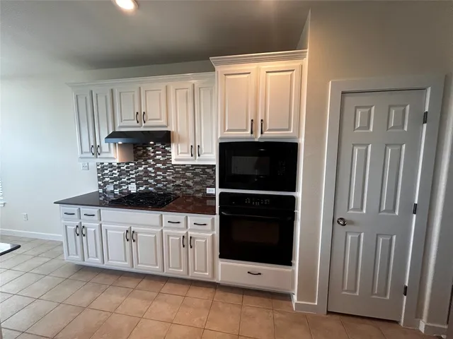 a kitchen with stainless steel appliances a sink and cabinets