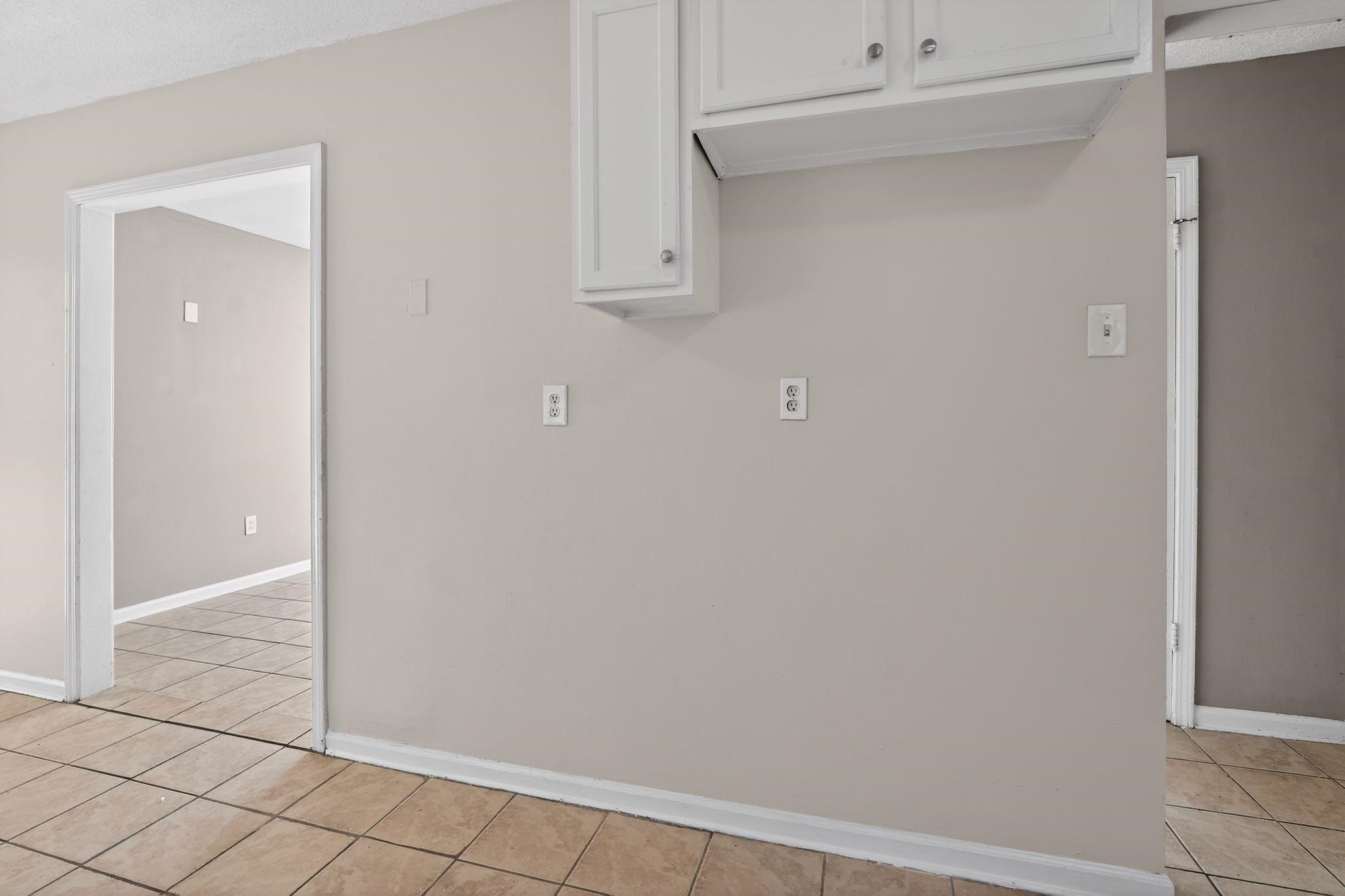 4306 University Street Memphis, TN 38127 - Photo 14 of 26 Kitchen with white cabinetry and light tile patterned floors