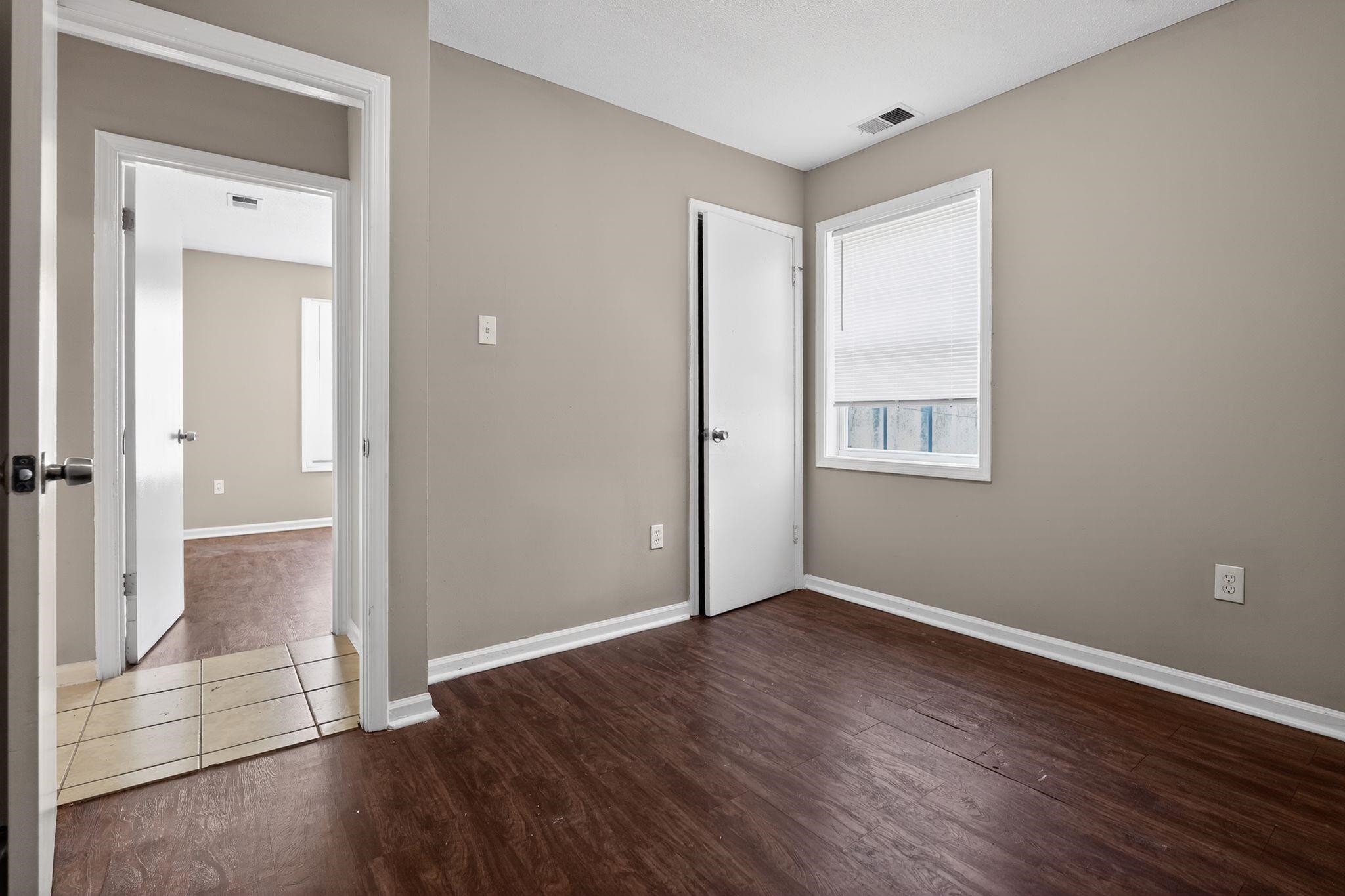 4306 University Street Memphis, TN 38127 - Photo 19 of 26 Unfurnished bedroom featuring dark wood finished floors and baseboards