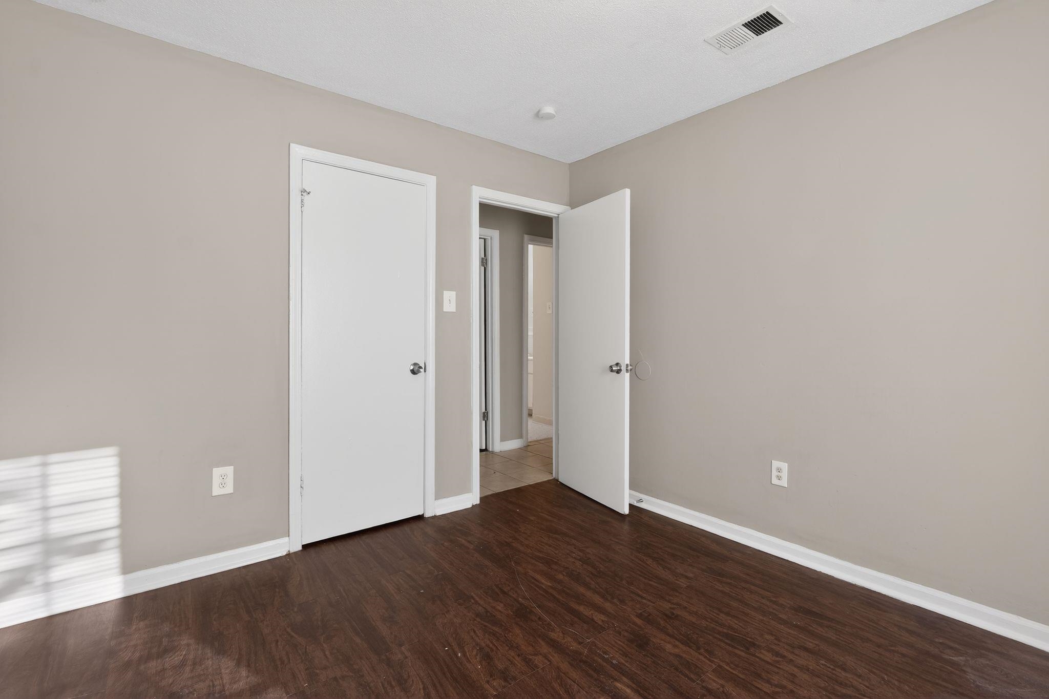 4306 University Street Memphis, TN 38127 - Photo 20 of 26 Unfurnished bedroom featuring baseboards and dark wood-style flooring