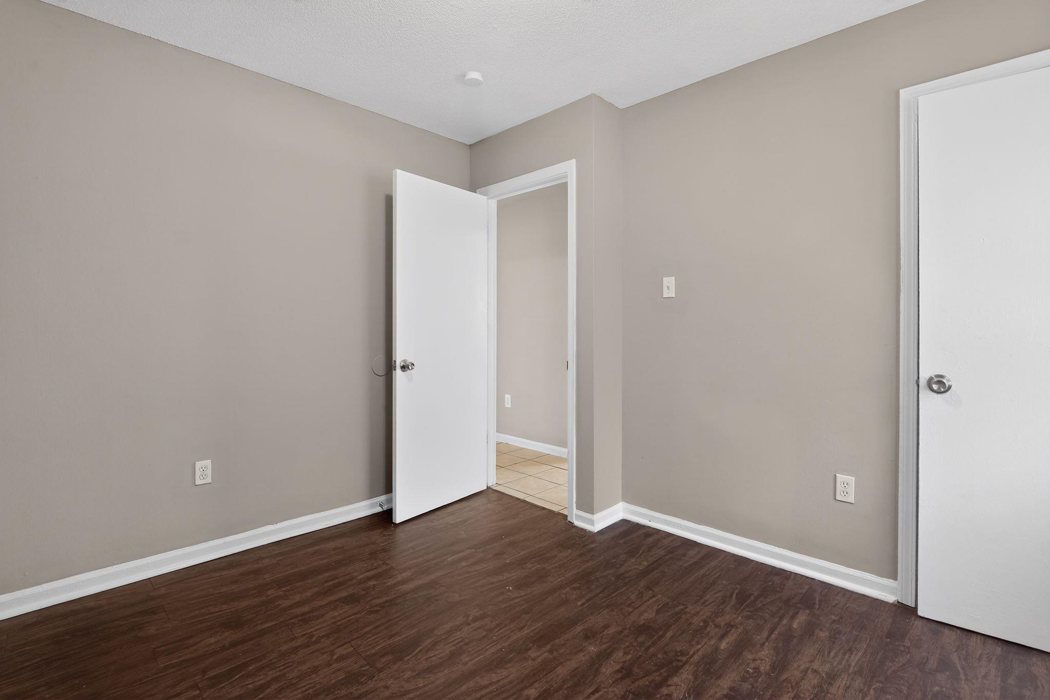 4306 University Street Memphis, TN 38127 - Photo 22 of 26 Unfurnished bedroom with baseboards and dark wood-type flooring