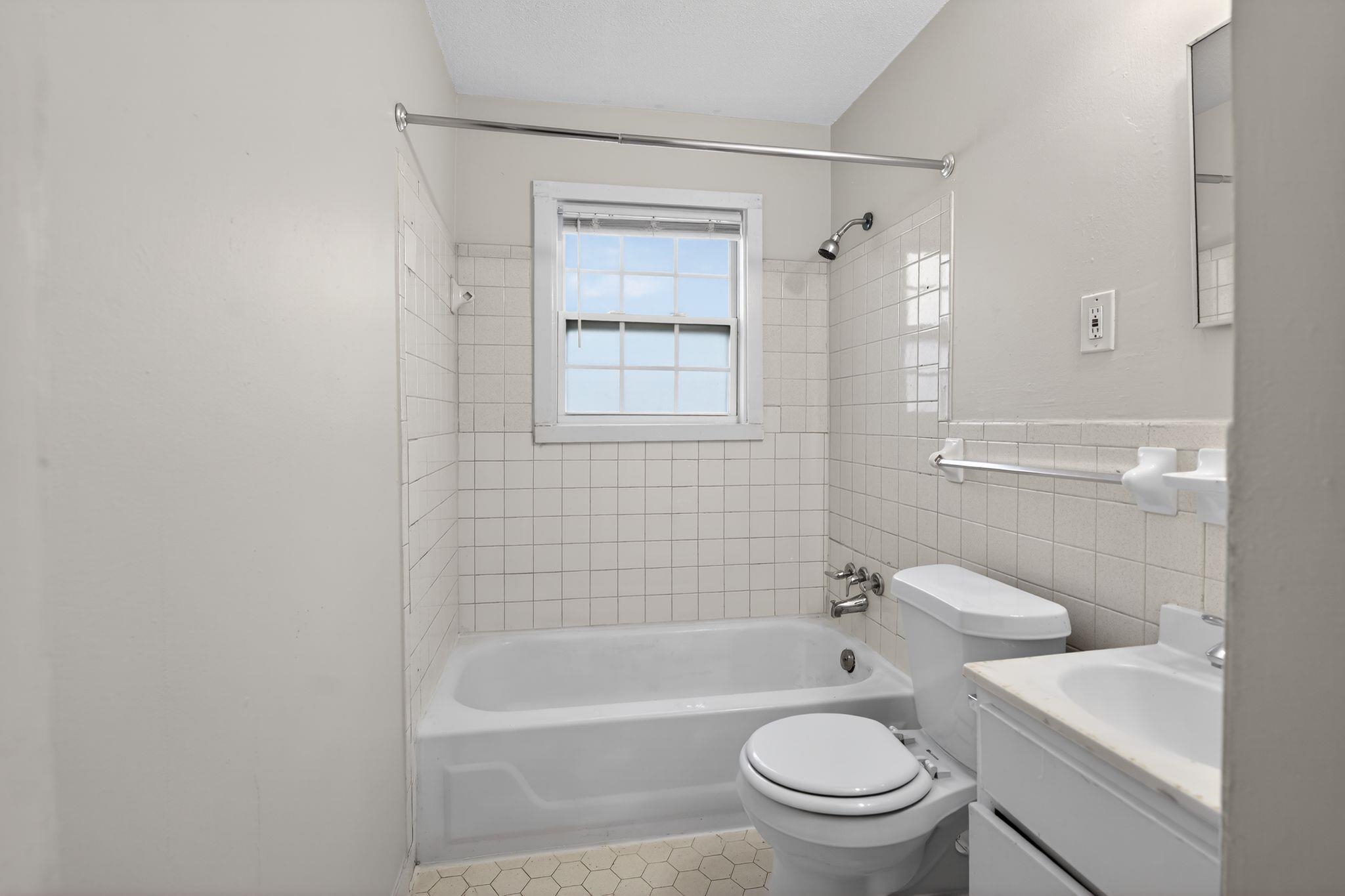 4306 University Street Memphis, TN 38127 - Photo 23 of 26 Bathroom featuring shower / tub combination, vanity, and tile walls
