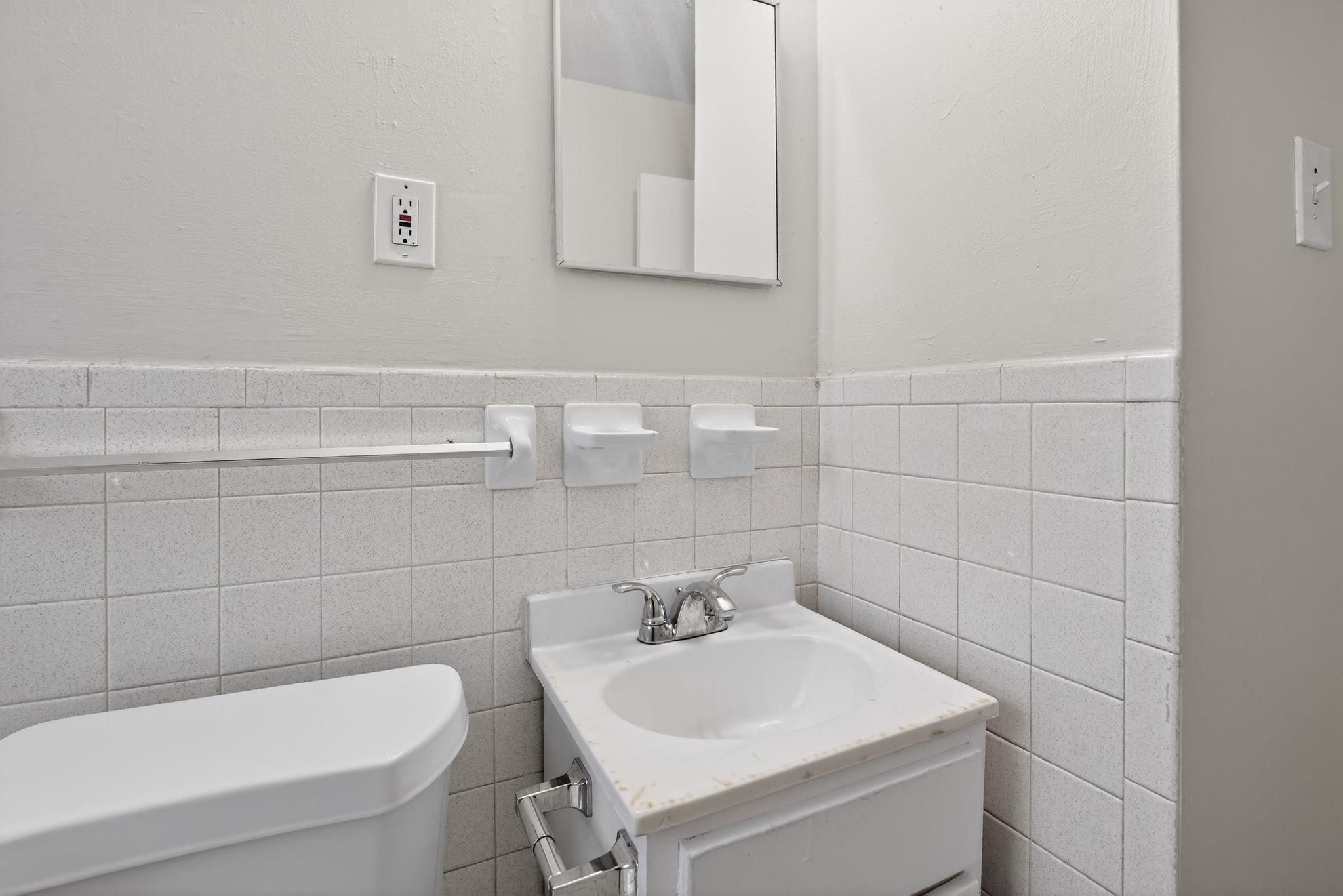 4306 University Street Memphis, TN 38127 - Photo 24 of 26 Bathroom featuring vanity and wainscoting