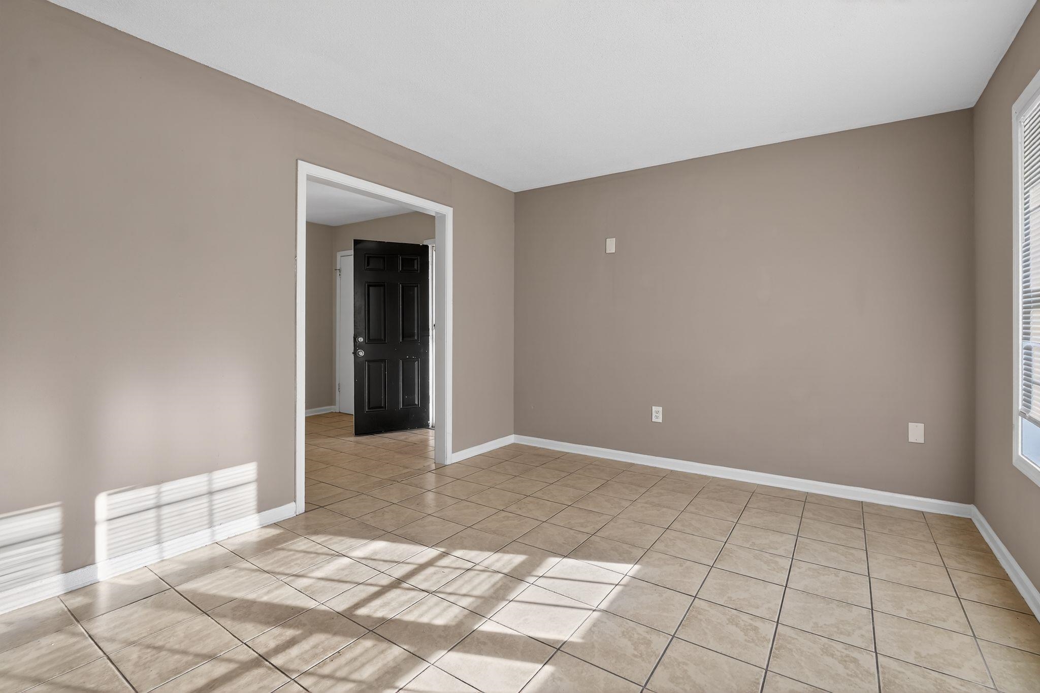 4306 University Street Memphis, TN 38127 - Photo 8 of 26 Spare room with baseboards and light tile patterned floors