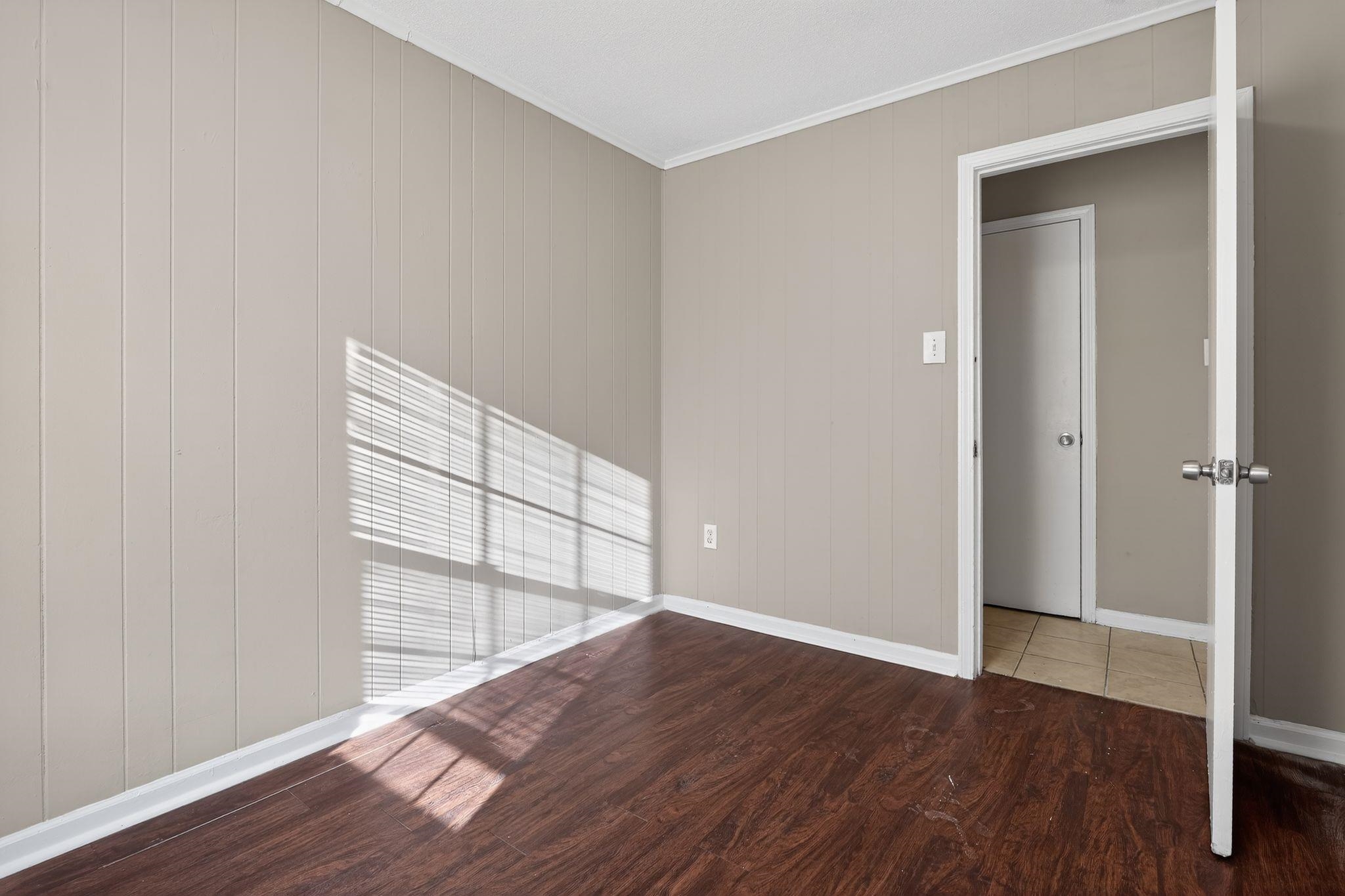 4306 University Street Memphis, TN 38127 - Photo 10 of 26 Empty room featuring wood finished floors and ornamental molding