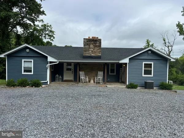 a front view of a house with a garden and yard