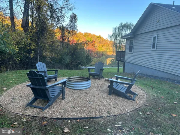 a backyard of a house with table and chairs
