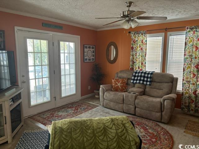 449 East Bank Dr Garden Murrells Inlet, SC 29576 - Photo 16 of 31 Living area with a textured ceiling, ornamental molding, and a wealth of natural light