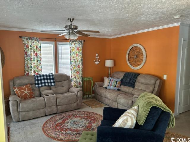 449 East Bank Dr Garden Murrells Inlet, SC 29576 - Photo 17 of 31 Living room featuring carpet, crown molding, and a textured ceiling