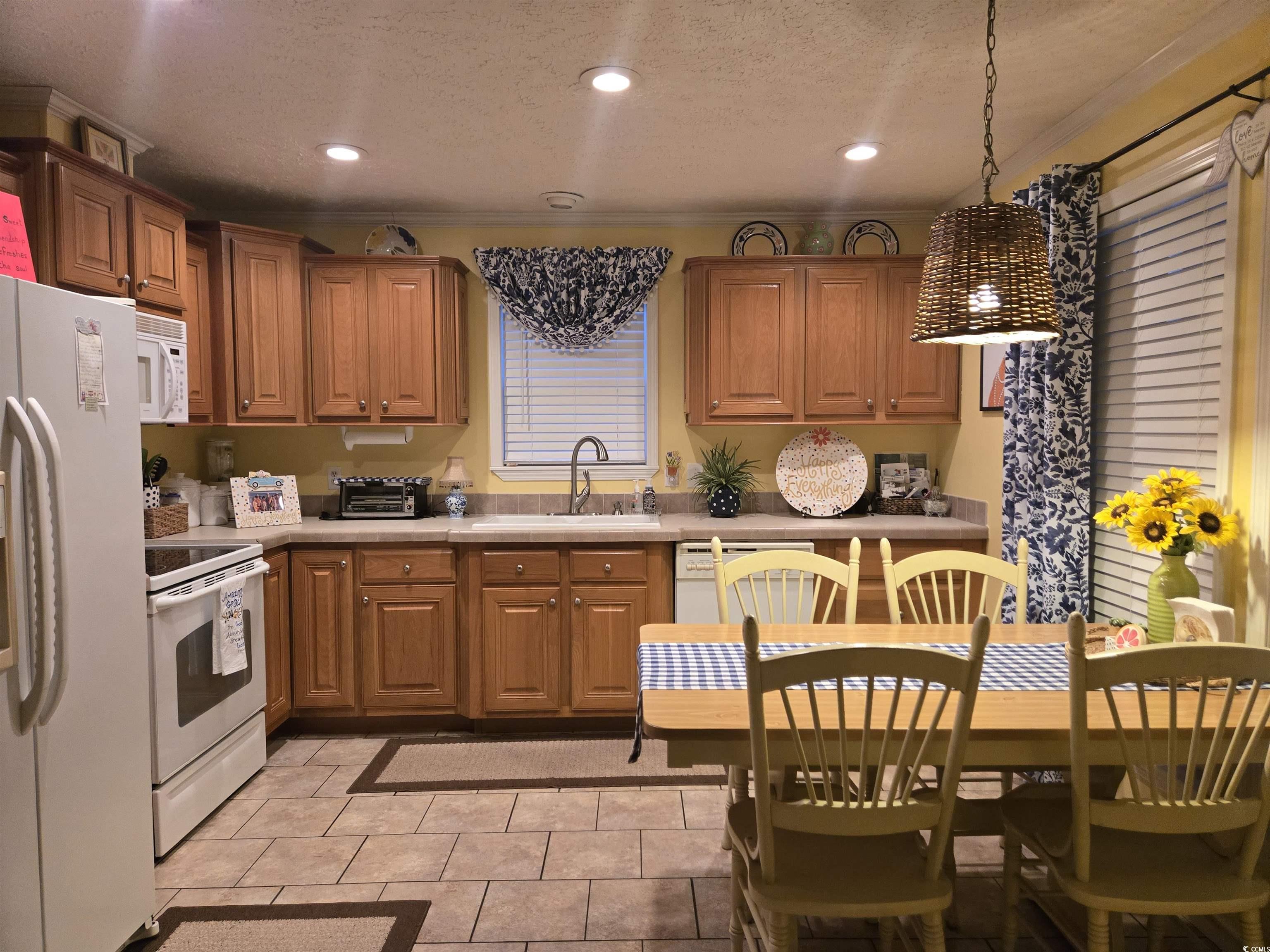 449 East Bank Dr Garden Murrells Inlet, SC 29576 - Photo 19 of 31 Kitchen with white appliances, light countertops, a textured ceiling, a sink, and recessed lighting