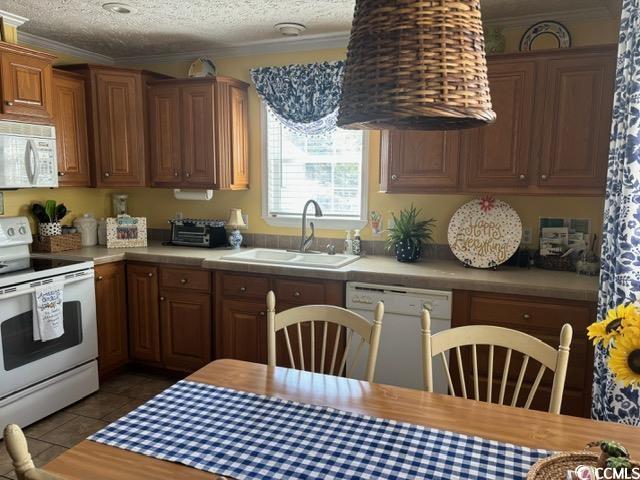 449 East Bank Dr Garden Murrells Inlet, SC 29576 - Photo 20 of 31 Kitchen featuring crown molding, white appliances, light countertops, and a sink