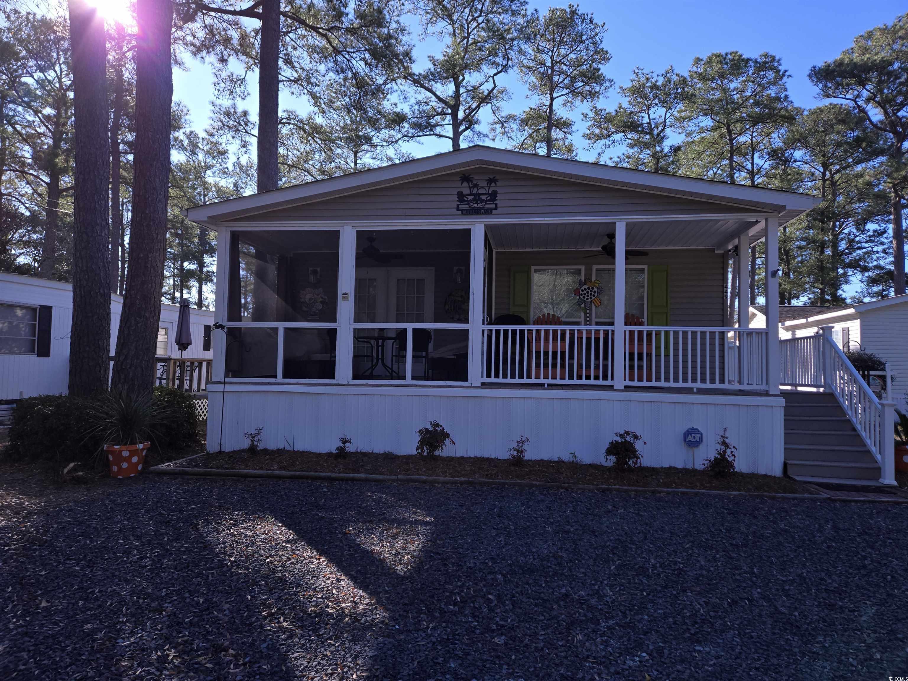 449 East Bank Dr Garden Murrells Inlet, SC 29576 - Photo 2 of 31 View of front facade with a sunroom, ceiling fan, and covered porch