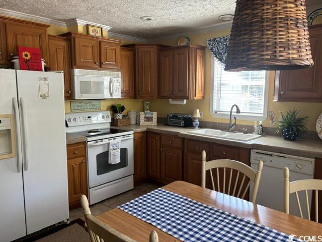 449 East Bank Dr Garden Murrells Inlet, SC 29576 - Photo 23 of 31 Kitchen featuring white appliances, ornamental molding, light countertops, a textured ceiling, and a sink