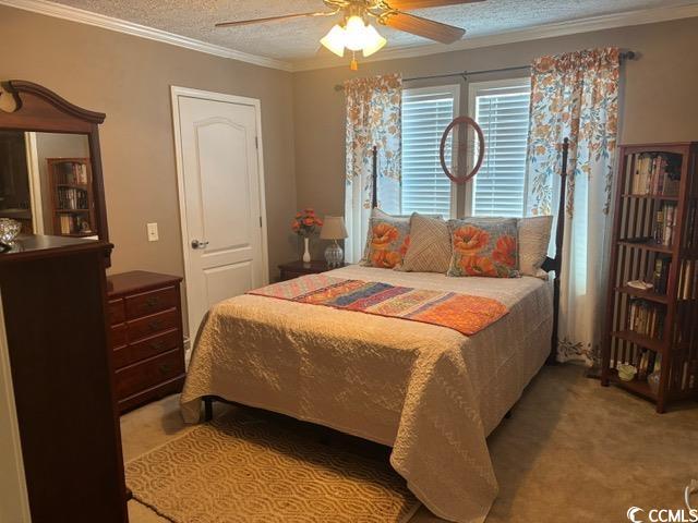 449 East Bank Dr Garden Murrells Inlet, SC 29576 - Photo 25 of 31 Bedroom with light carpet, crown molding, ceiling fan, and a textured ceiling