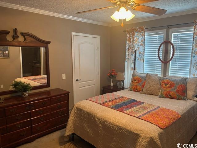 449 East Bank Dr Garden Murrells Inlet, SC 29576 - Photo 26 of 31 Carpeted bedroom featuring a textured ceiling, a ceiling fan, and crown molding
