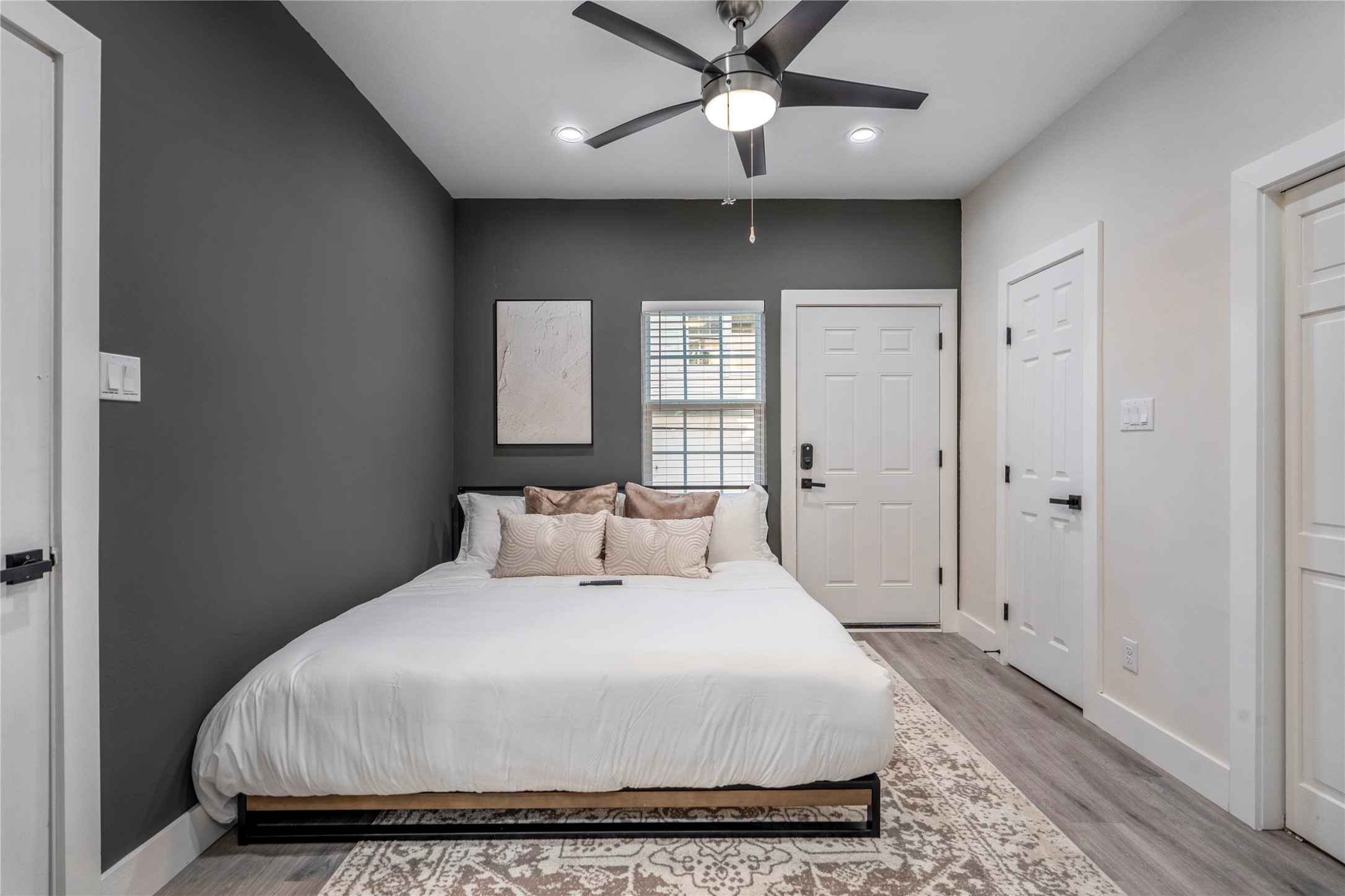 5 Estelle Street, Unit 1 Houston, TX 77003 - Photo 14 of 33 a bedroom with a large bed and a chandelier