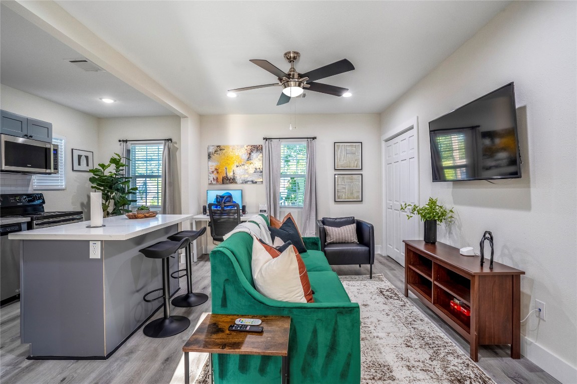 5 Estelle Street, Unit 1 Houston, TX 77003 - Photo 24 of 33 a living room with furniture a flat screen tv and kitchen view