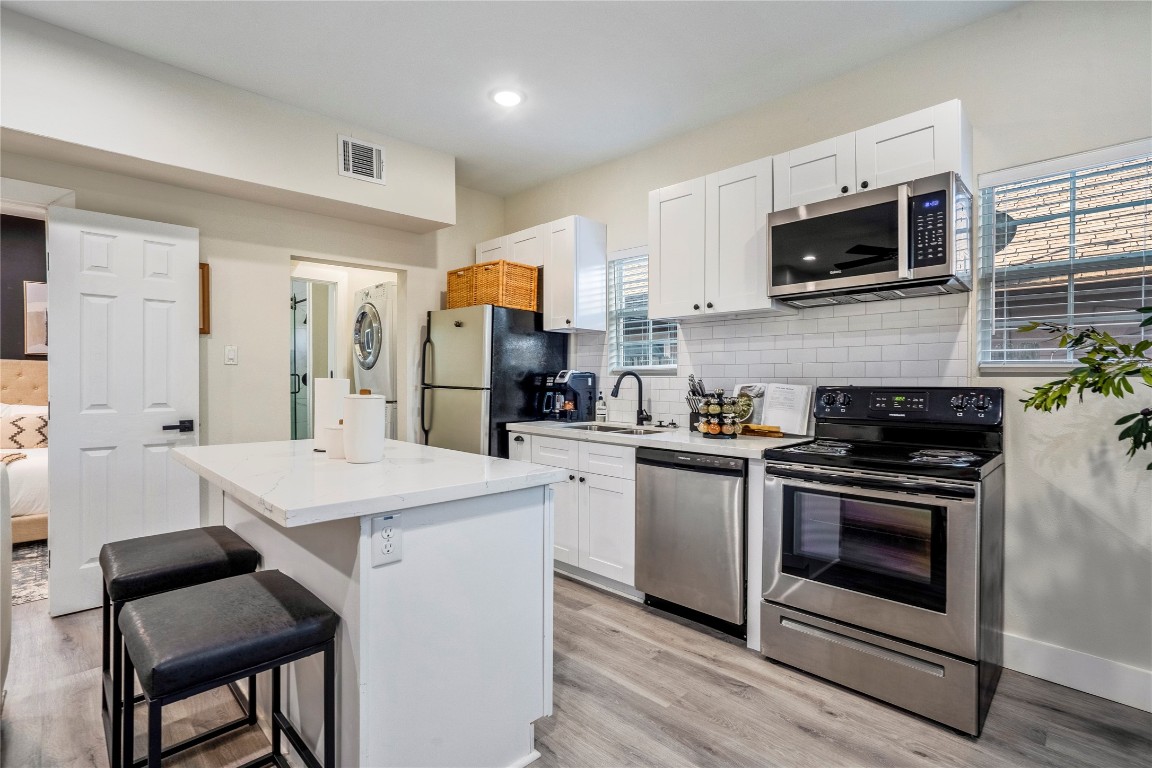 5 Estelle Street, Unit 1 Houston, TX 77003 - Photo 8 of 33 a kitchen with a stove a sink and a refrigerator