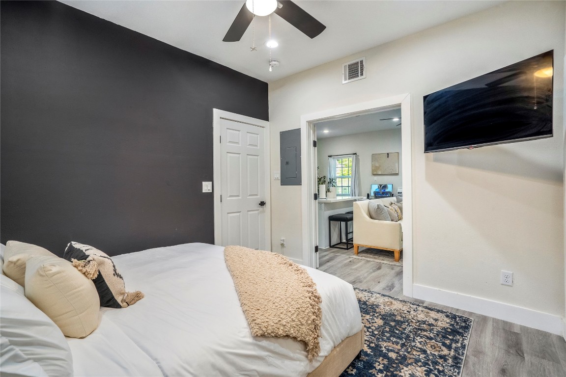 5 Estelle Street, Unit 1 Houston, TX 77003 - Photo 10 of 33 a bedroom with a bed and a chandelier