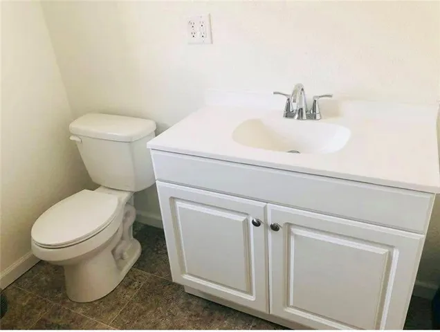 a white toilet sitting next to a bathroom sink