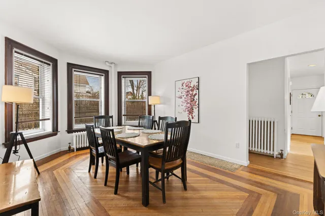a view of a a dining room with furniture window and wooden floor