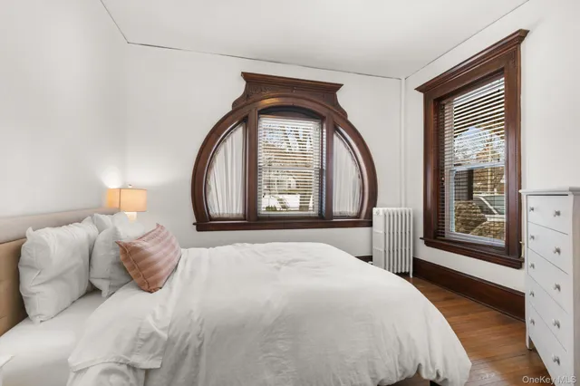 a bedroom with a bed and a large window with outer view