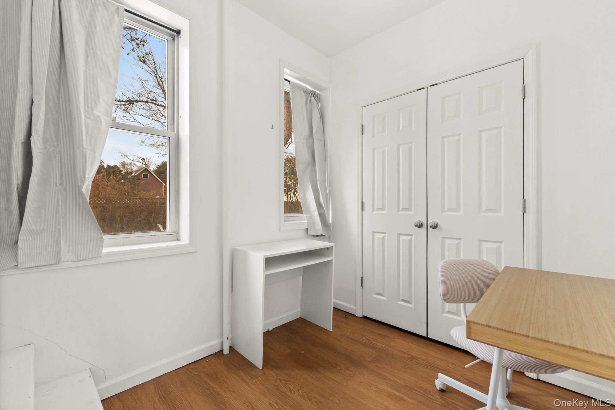 16 Bedford Road, Unit 1 Katonah, NY 10536 - Photo 7 of 13 an entryway with wooden floor and cabinet