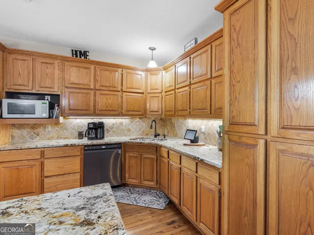 a dining room with furniture a chandelier and wooden floor