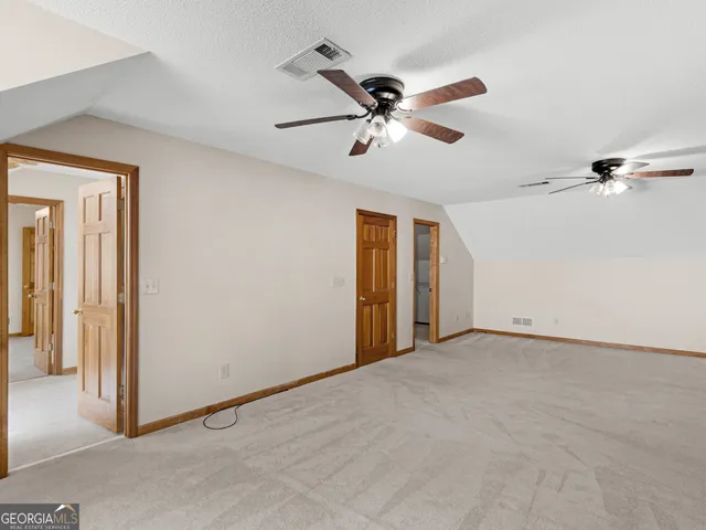 a view of a patio with table and chairs next to a yard