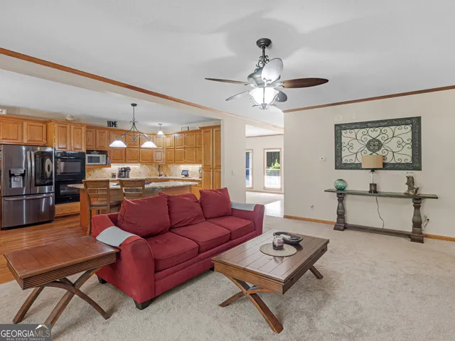 a kitchen with stainless steel appliances granite countertop a sink dishwasher stove and cabinets with wooden floor