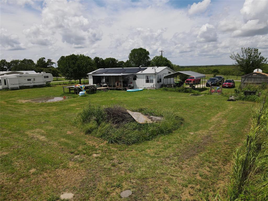 15962 Fritcher Road Pilot Point, TX 76258 - Photo 11 of 24 View of grassy yard featuring a detached carport