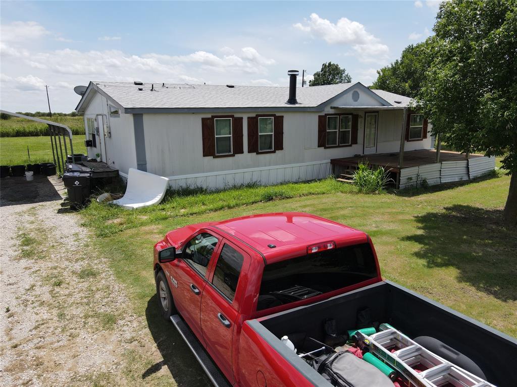 15962 Fritcher Road Pilot Point, TX 76258 - Photo 16 of 24 View of front of house with a front lawn and roof with shingles