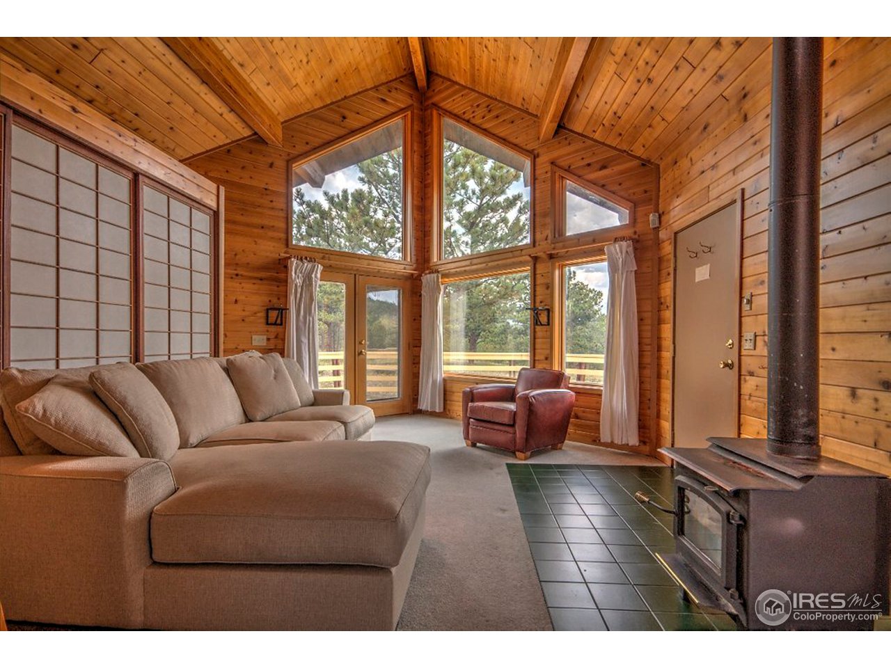 238 Valley Road Lyons, CO 80540 - Photo 12 of 28 a living room with furniture and floor to ceiling windows