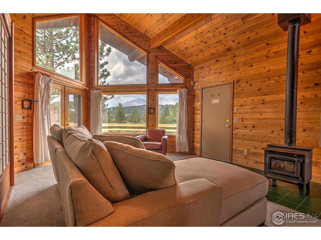 238 Valley Road Lyons, CO 80540 - Photo 3 of 28 a bedroom with a bed and wooden floor