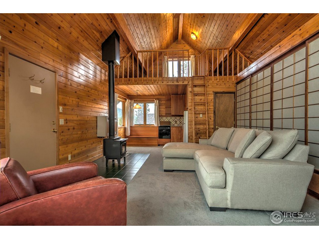 238 Valley Road Lyons, CO 80540 - Photo 7 of 28 a living room with furniture a ceiling fan and a window