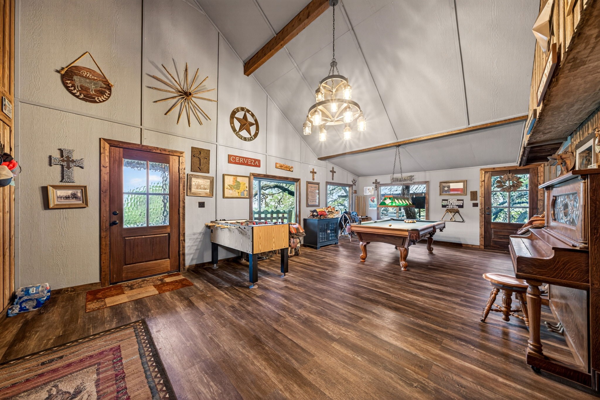 1850 Ranch Road 337 Leakey, TX 78873 - Photo 24 of 50 Spacious living area featuring updated flooring and a wood-burning fireplace for cozy Hill Country evenings