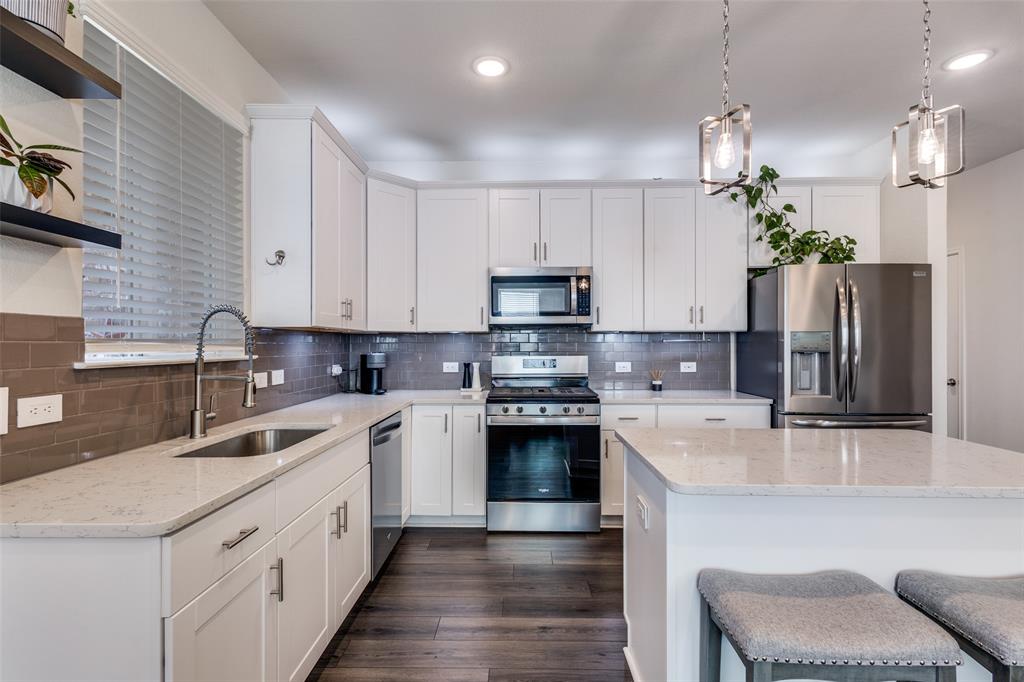 White is timeless! Indulge in the culinary delight of the chef's kitchen, where a spacious eat-in island takes center stage, inviting you to gather and create cherished memories in this open and generously proportioned space.