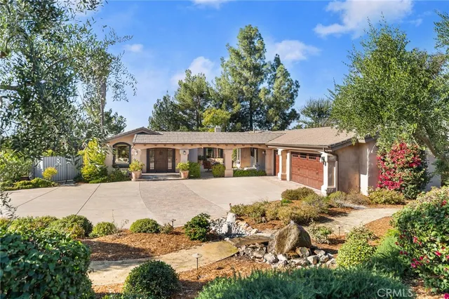 a front view of a house with a garden