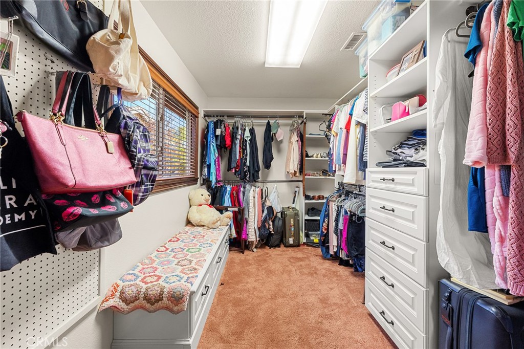 1632 Country Club Drive Redlands, CA 92373 - Photo 24 of 54 a view of walk in closet with clothes and shoes