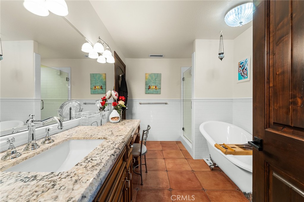 1632 Country Club Drive Redlands, CA 92373 - Photo 25 of 54 a bathroom with a tub double vanity sink and a large mirror