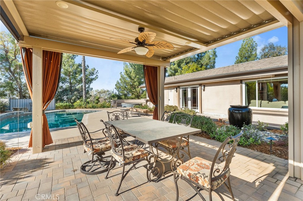 1632 Country Club Drive Redlands, CA 92373 - Photo 46 of 54 a view of a patio with table and chairs and floor to ceiling window with wooden floor