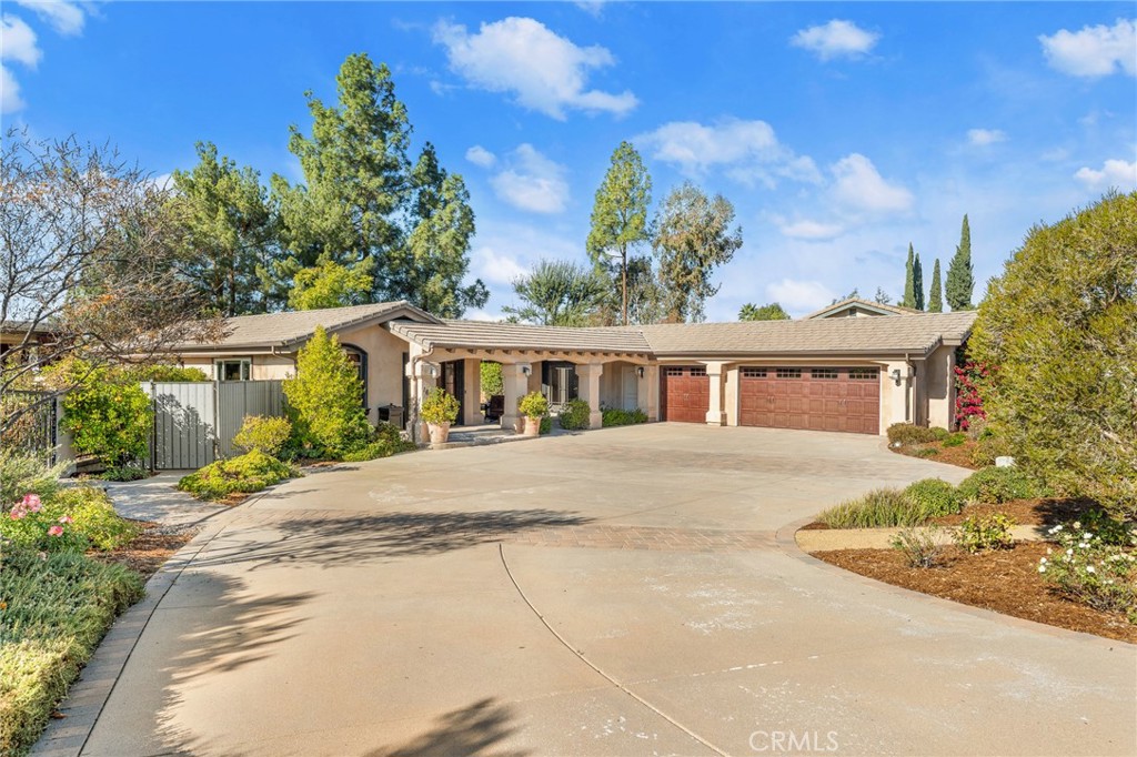 1632 Country Club Drive Redlands, CA 92373 - Photo 52 of 54 a front view of a house with a yard and potted plants