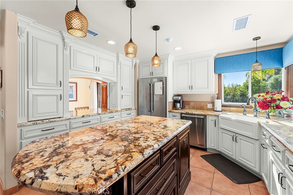 1632 Country Club Drive Redlands, CA 92373 - Photo 10 of 54 a kitchen with stainless steel appliances granite countertop a stove a sink and a refrigerator