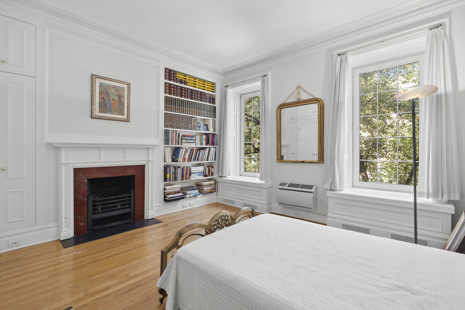 152 East 63rd Street, Unit 2 Manhattan, NY 10065 - Photo 15 of 23 a bedroom with a bed and a fireplace