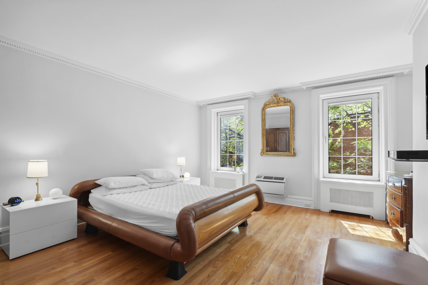 152 East 63rd Street, Unit 2 Manhattan, NY 10065 - Photo 18 of 23 a bedroom with a bed and windows