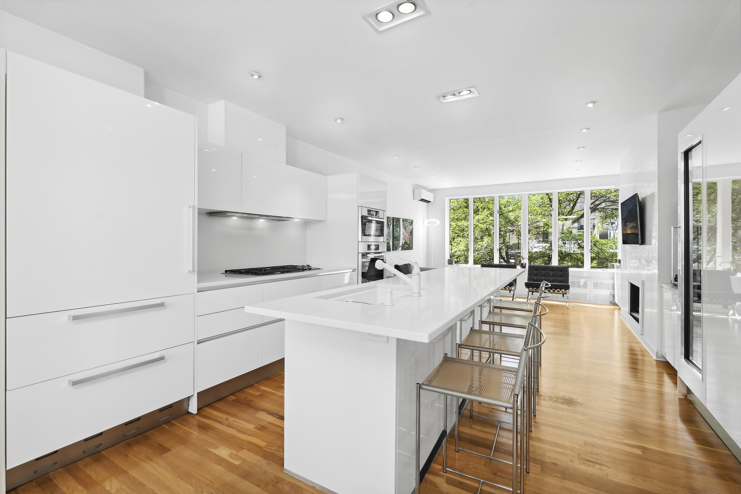 152 East 63rd Street, Unit 2 Manhattan, NY 10065 - Photo 2 of 23 a large white kitchen with a large window