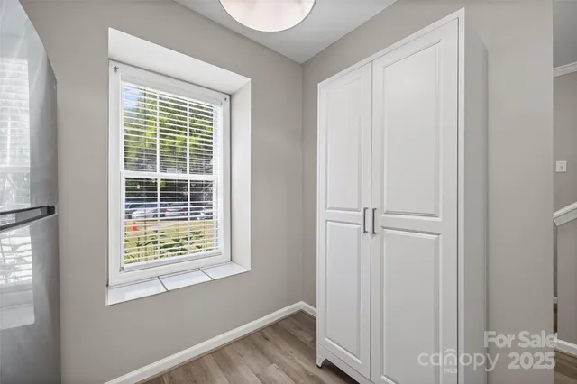 a view of small space with wooden floor and windows