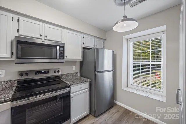 a kitchen with a refrigerator stove and microwave